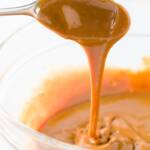 Dulce de leche dripping off of a spoon