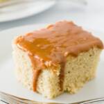 Slice of Dulce de leche cake on a plate with dulce de leche dripping down the side