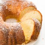 Pound cake made in a Bundt pan with a few slices cut and leaning over