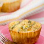 A crab and asparagus mini quiche resting on a plate
