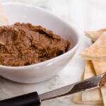 Chocolate hummus in a bowl with fresh pita bread nearby