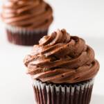 Two chocolate cupcakes on a white background