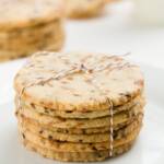 Stack of coffee cookies wrapped in bakers twine with other stacks in the background