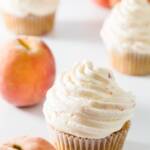 Cupcakes topped with peach whipped cream
