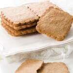 White plate with a stack of speculoos cookies on it