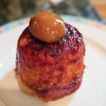 Finished microwave banana bread on a plate with a scoop of dulce de leche.