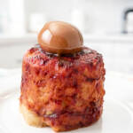 Finished microwave banana bread on a plate with a scoop of dulce de leche.